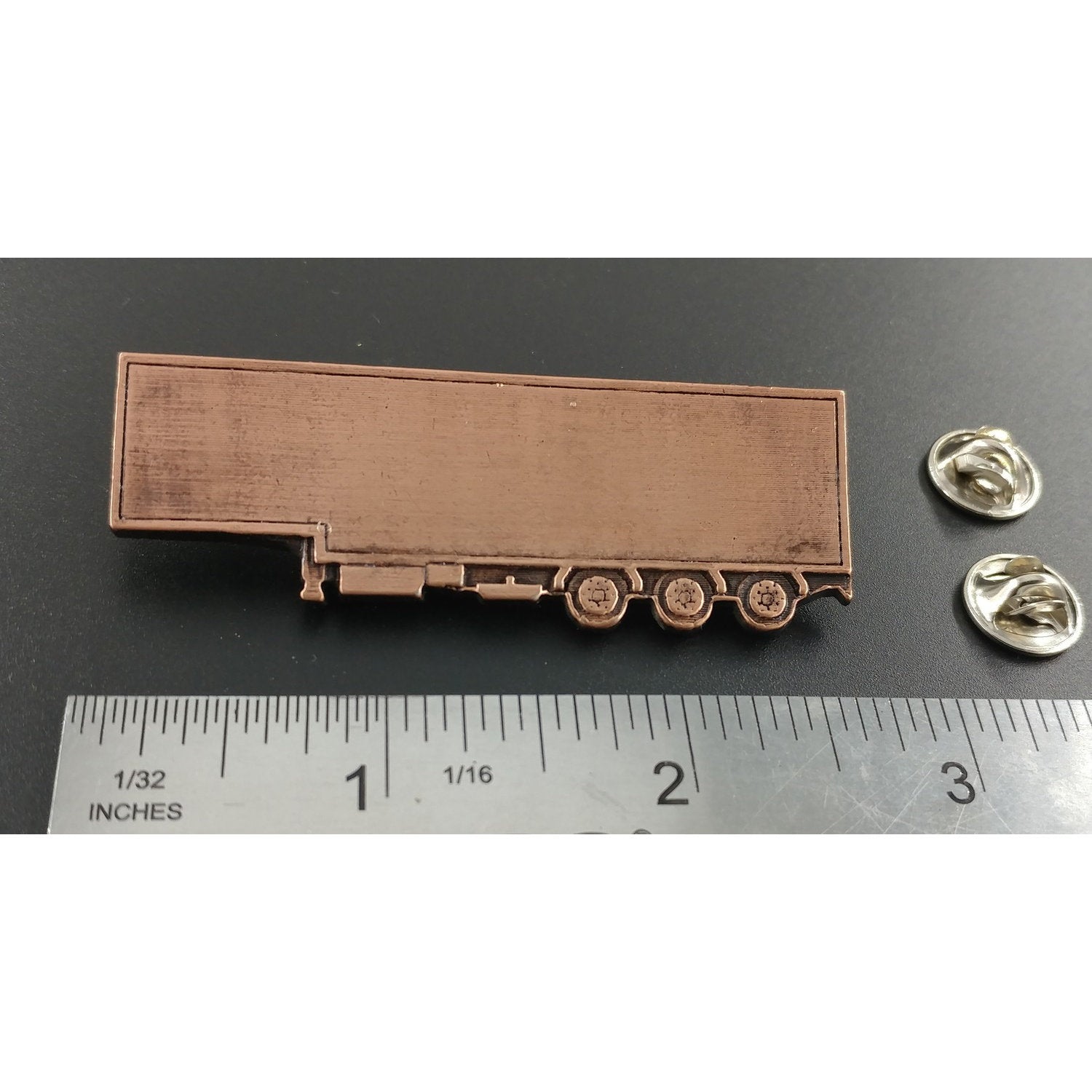 A handcrafted Semi Truck Trailer Pin next to a ruler, available for sale at Creativeartisan.com - the image offers a sense of scale