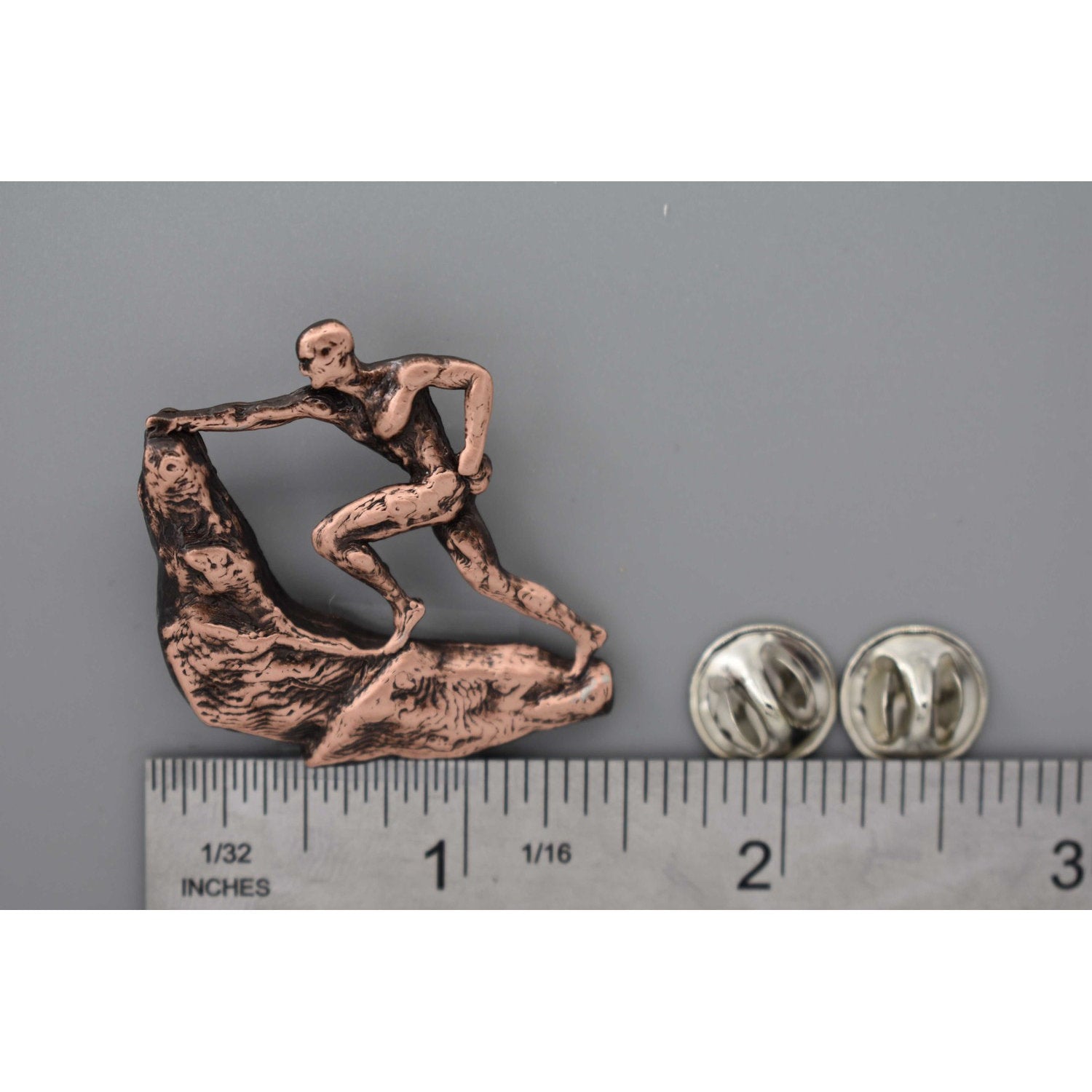 A handcrafted Rock Climber Male Pin next to a ruler, available for sale at Creativeartisan.com - the image offers a sense of scale