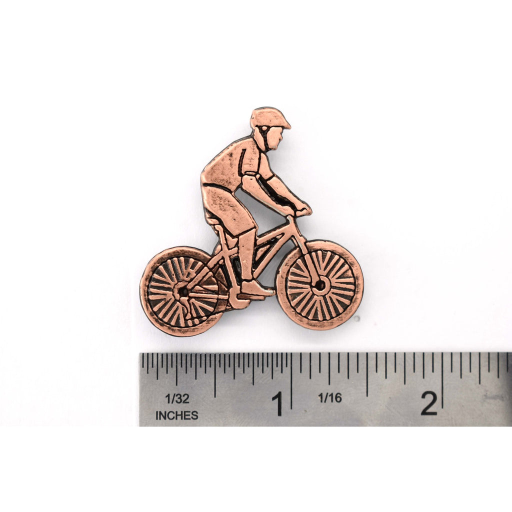 A handcrafted Bicycler Pin next to a ruler, available for sale at Creativeartisan.com - the image offers a sense of scale