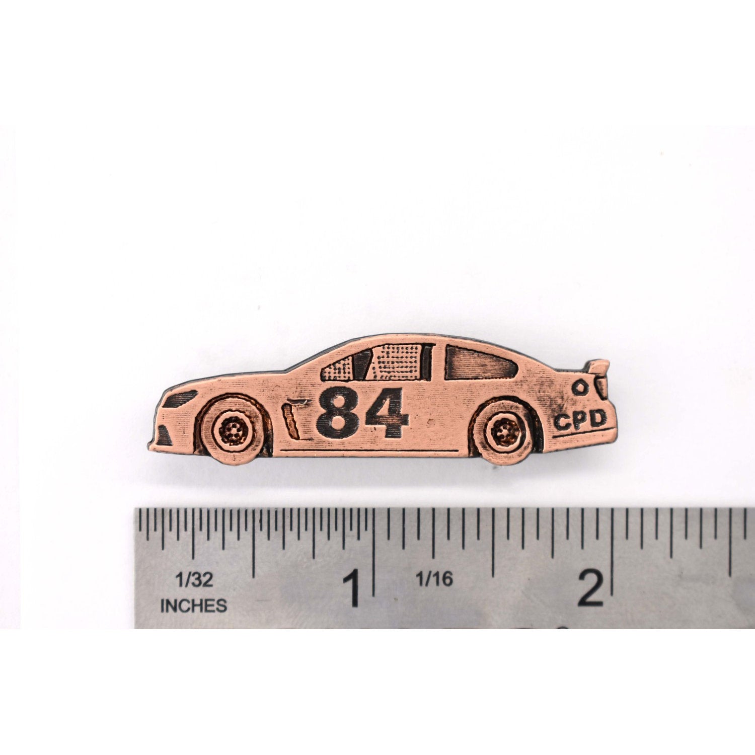 A handcrafted Rainbow Leaping Alaska Pin next to a ruler, available for sale at Creativeartisan.com - the image offers a sense of scale