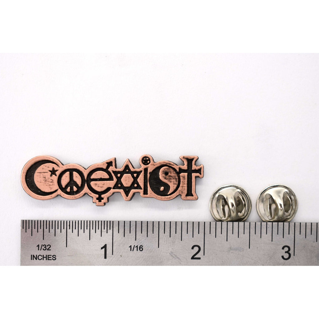 A handcrafted Coexist Pin next to a ruler, available for sale at Creativeartisan.com - the image offers a sense of scale