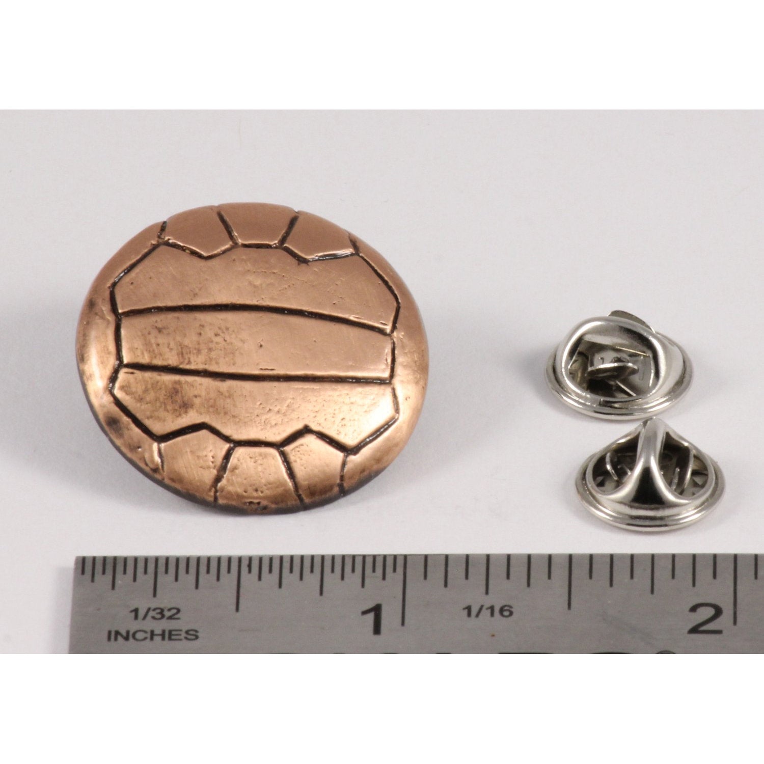 A handcrafted Soccer Ball W Lines Pin next to a ruler, available for sale at Creativeartisan.com - the image offers a sense of scale