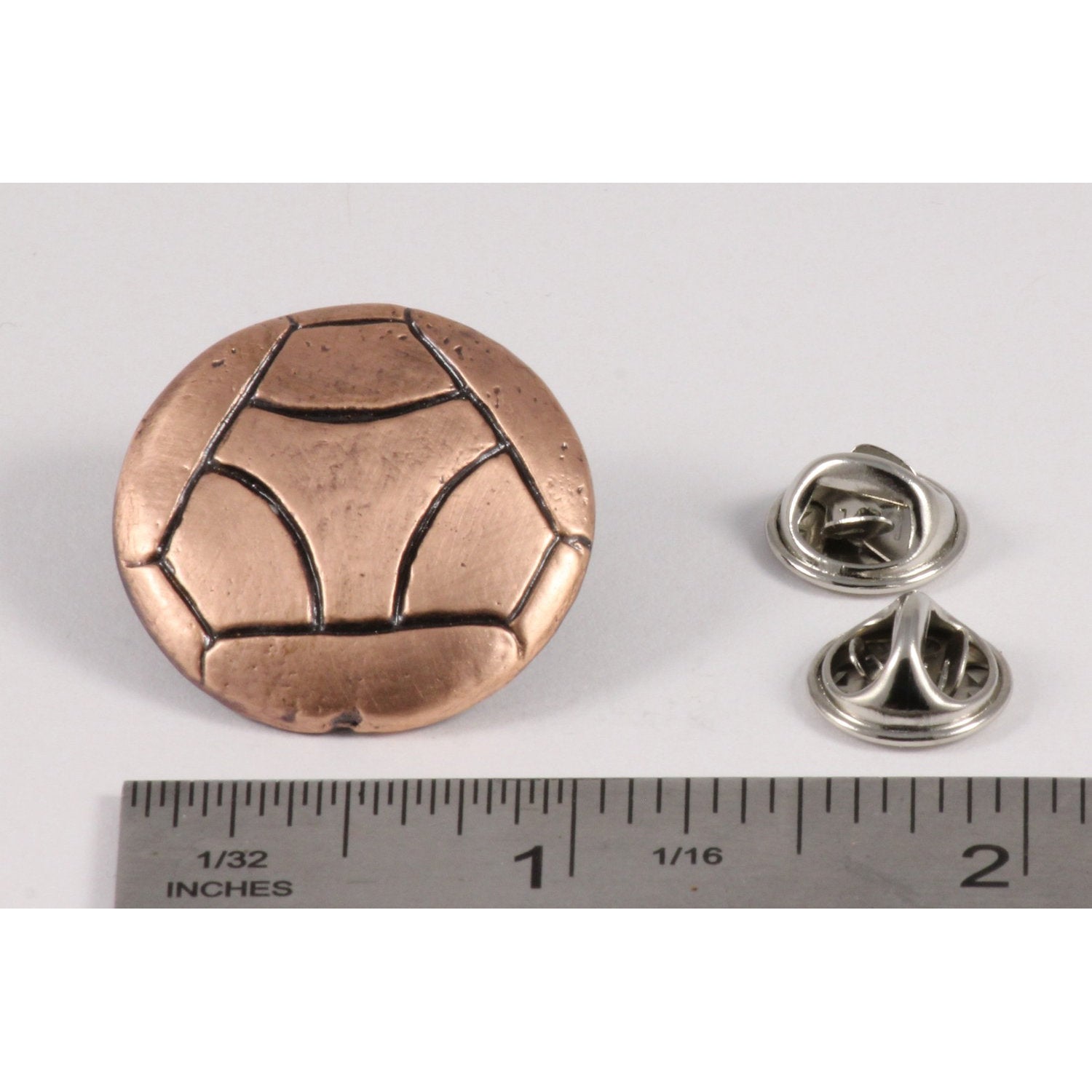 A handcrafted Soccer Ball W Y Pin next to a ruler, available for sale at Creativeartisan.com - the image offers a sense of scale