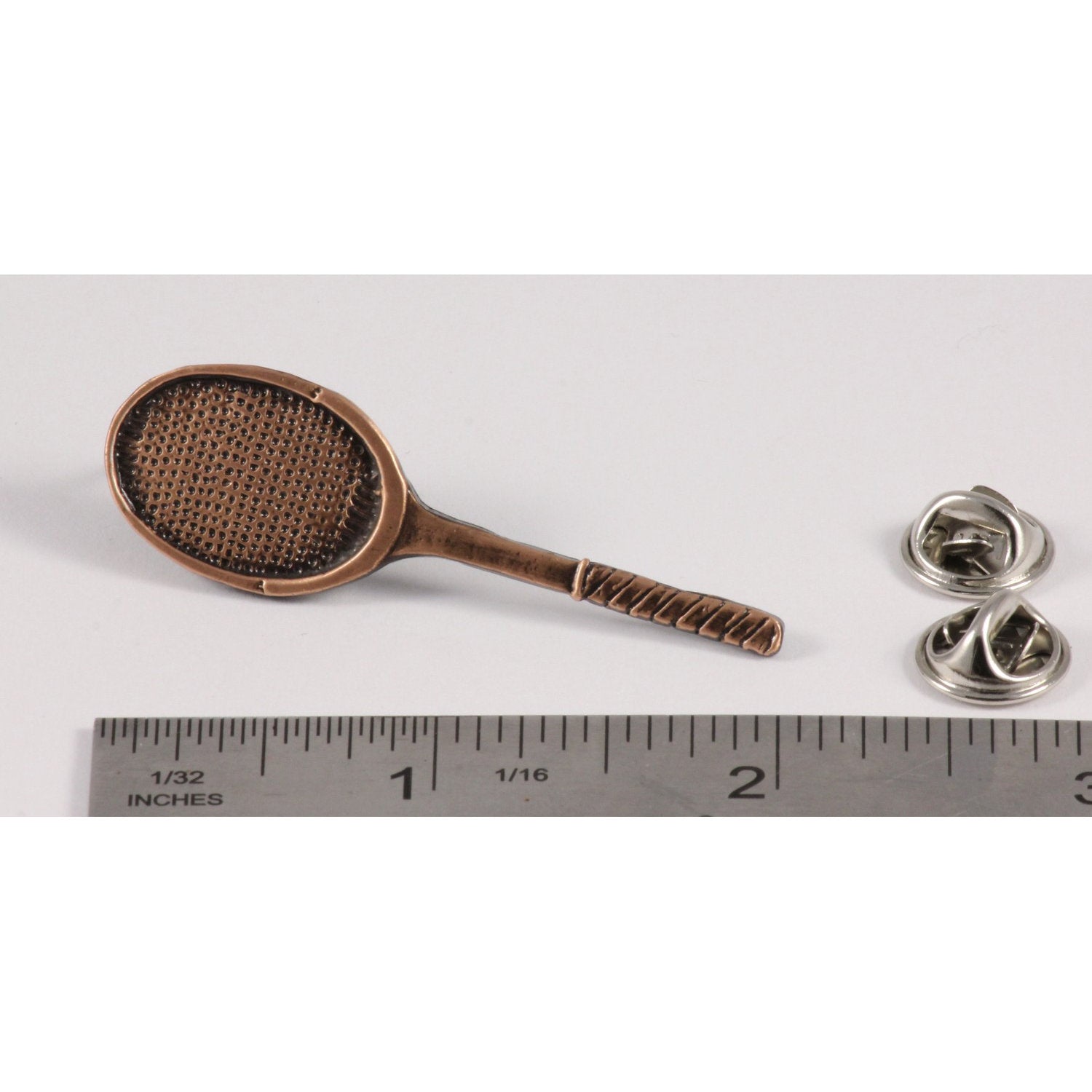 A handcrafted Tennis Racquet Pin next to a ruler, available for sale at Creativeartisan.com - the image offers a sense of scale