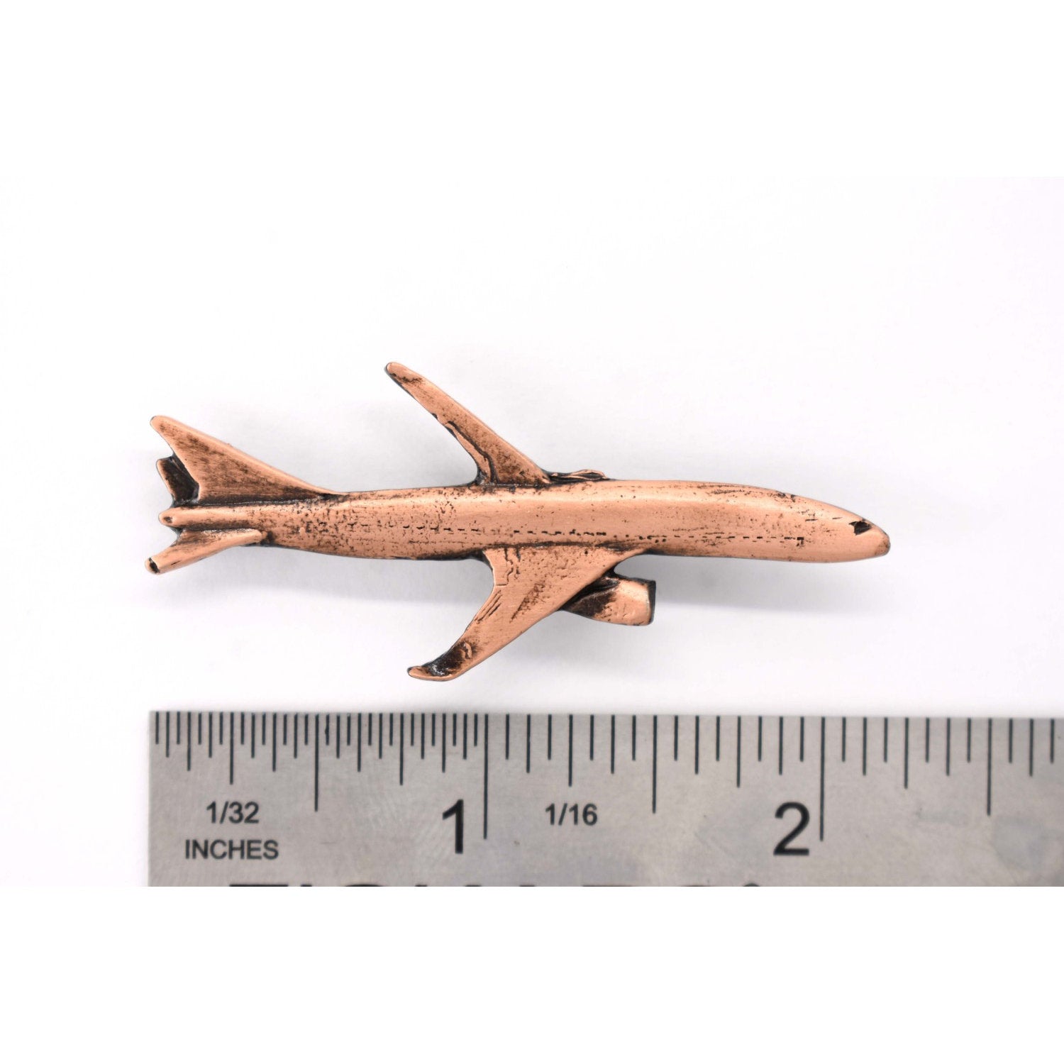 A handcrafted Jetliner Pin next to a ruler, available for sale at Creativeartisan.com - the image offers a sense of scale
