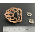 A handcrafted Bear Print Alaska Pin next to a ruler, available for sale at Creativeartisan.com - the image offers a sense of scale