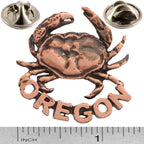 A handcrafted Dungeness Crab Oregon Pin next to a ruler, available for sale at Creativeartisan.com - the image offers a sense of scale