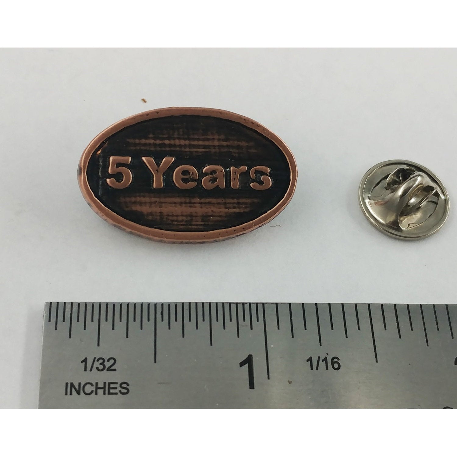 A handcrafted 5 Year Pin next to a ruler, available for sale at Creativeartisan.com - the image offers a sense of scale