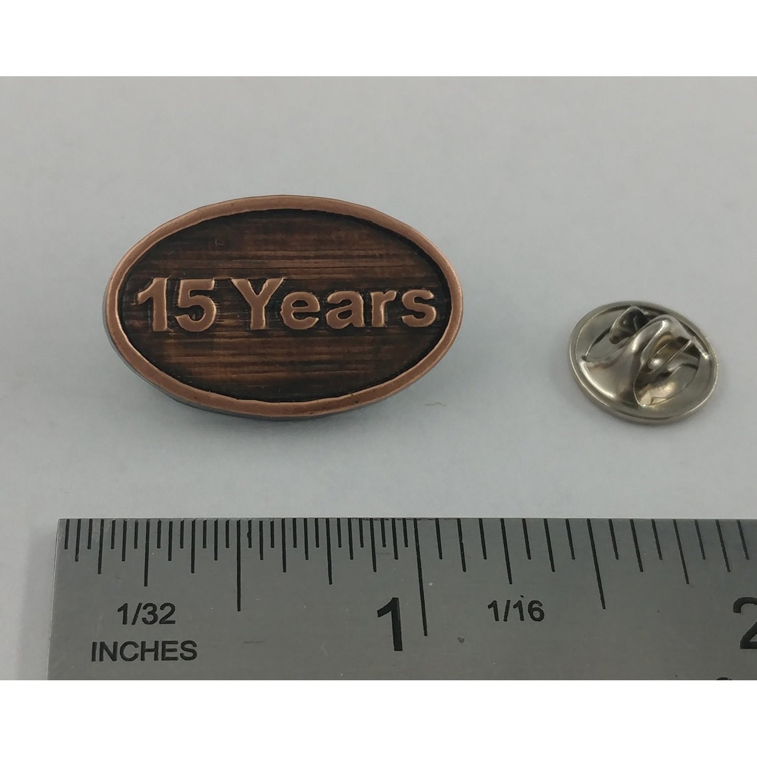 A handcrafted 15 Year Pin next to a ruler, available for sale at Creativeartisan.com - the image offers a sense of scale
