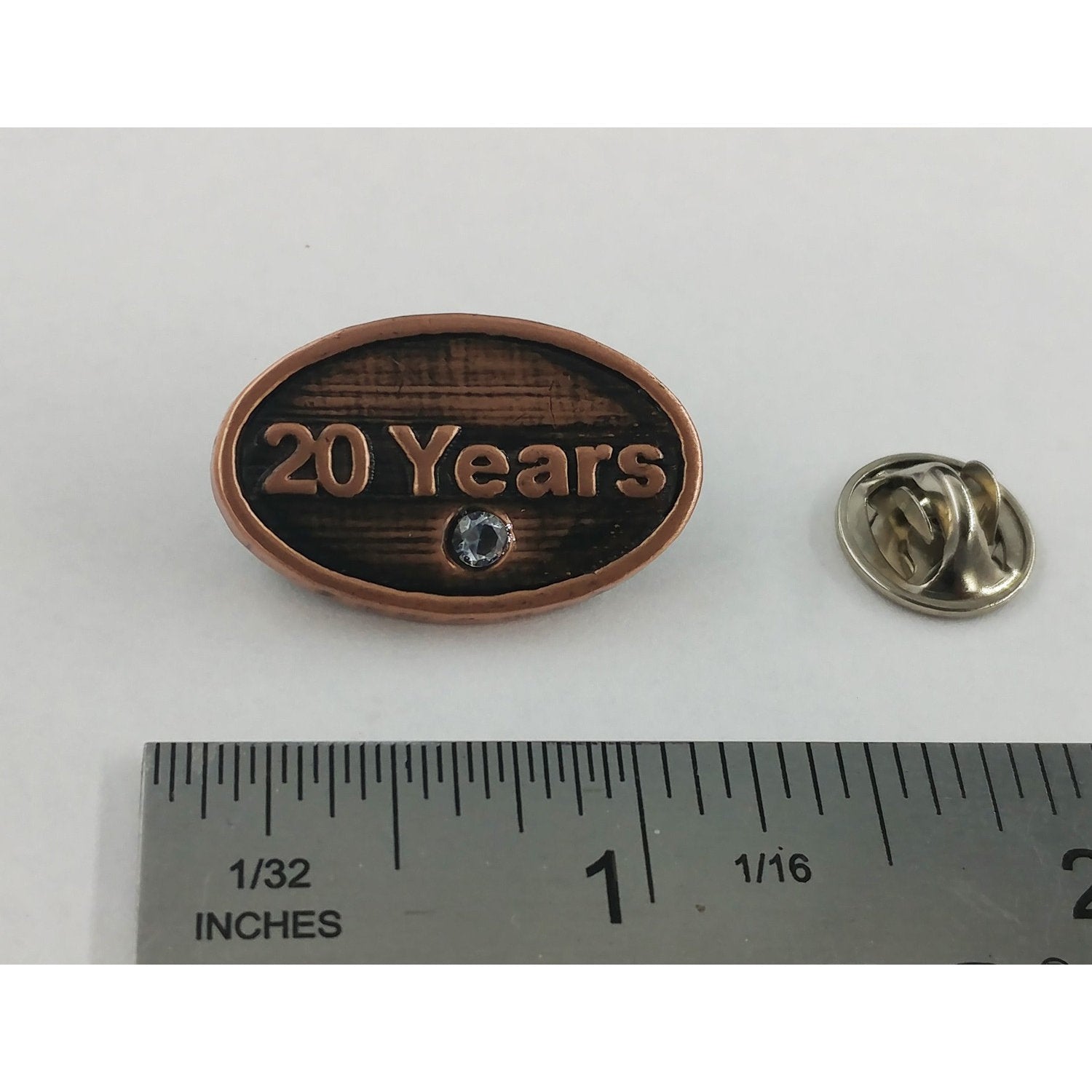 A handcrafted 20 Year Pin next to a ruler, available for sale at Creativeartisan.com - the image offers a sense of scale
