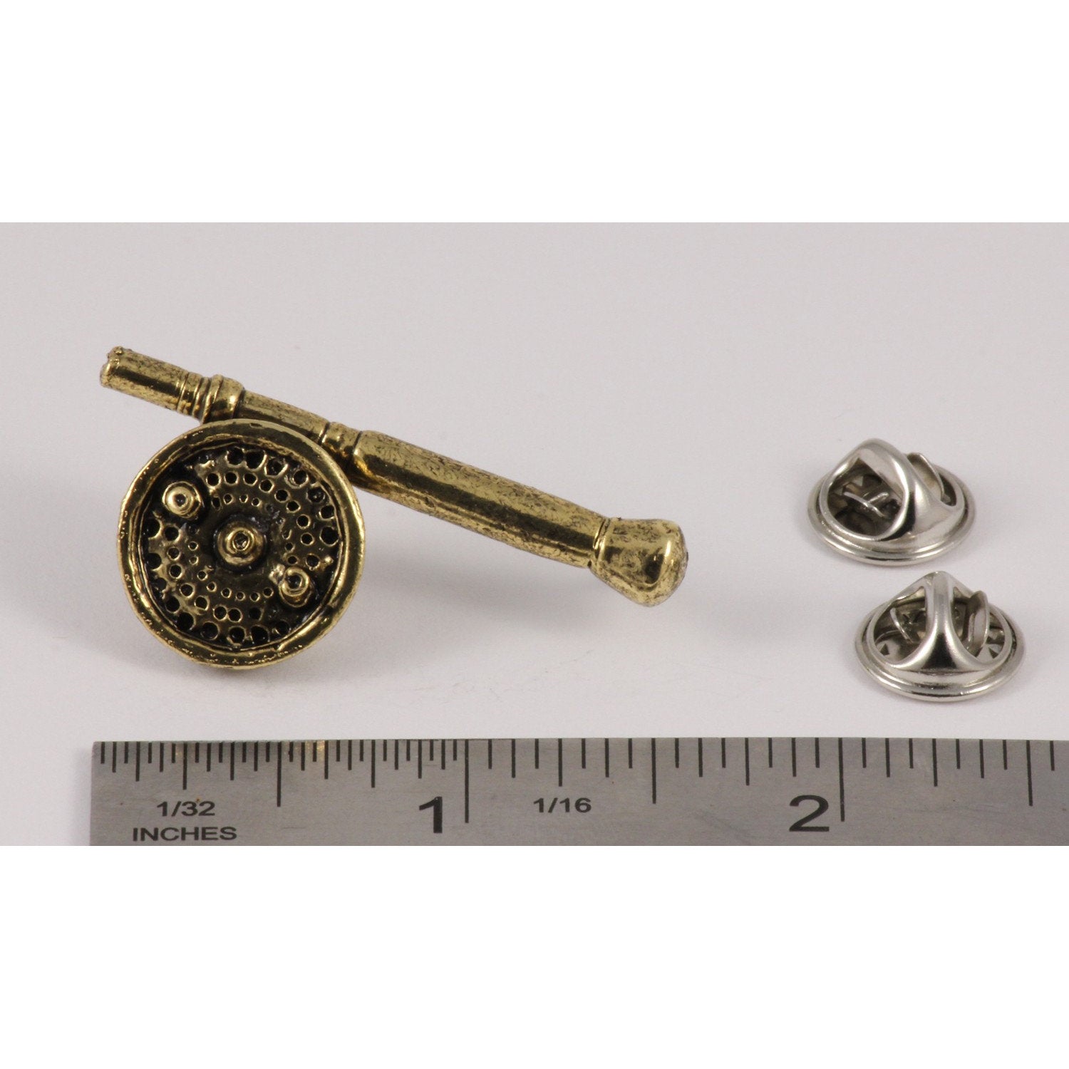 A handcrafted Saltwater Fly Rod Reel Pin next to a ruler, available for sale at Creativeartisan.com - the image offers a sense of scale