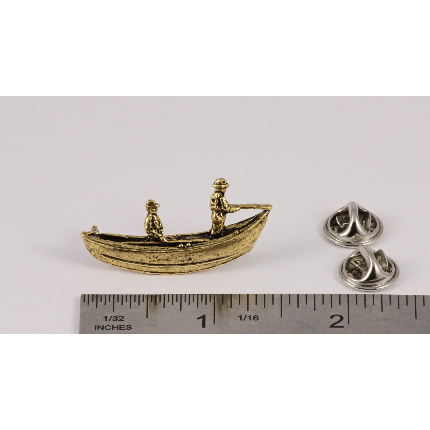 A handcrafted Drift Boat Pin next to a ruler, available for sale at Creativeartisan.com - the image offers a sense of scale