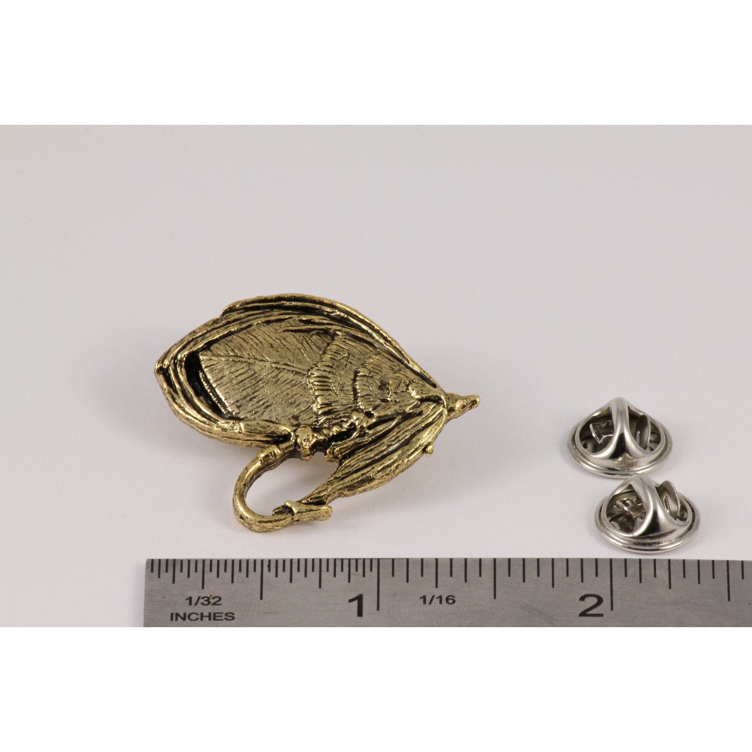 A handcrafted Salmon Fly Pin next to a ruler, available for sale at Creativeartisan.com - the image offers a sense of scale