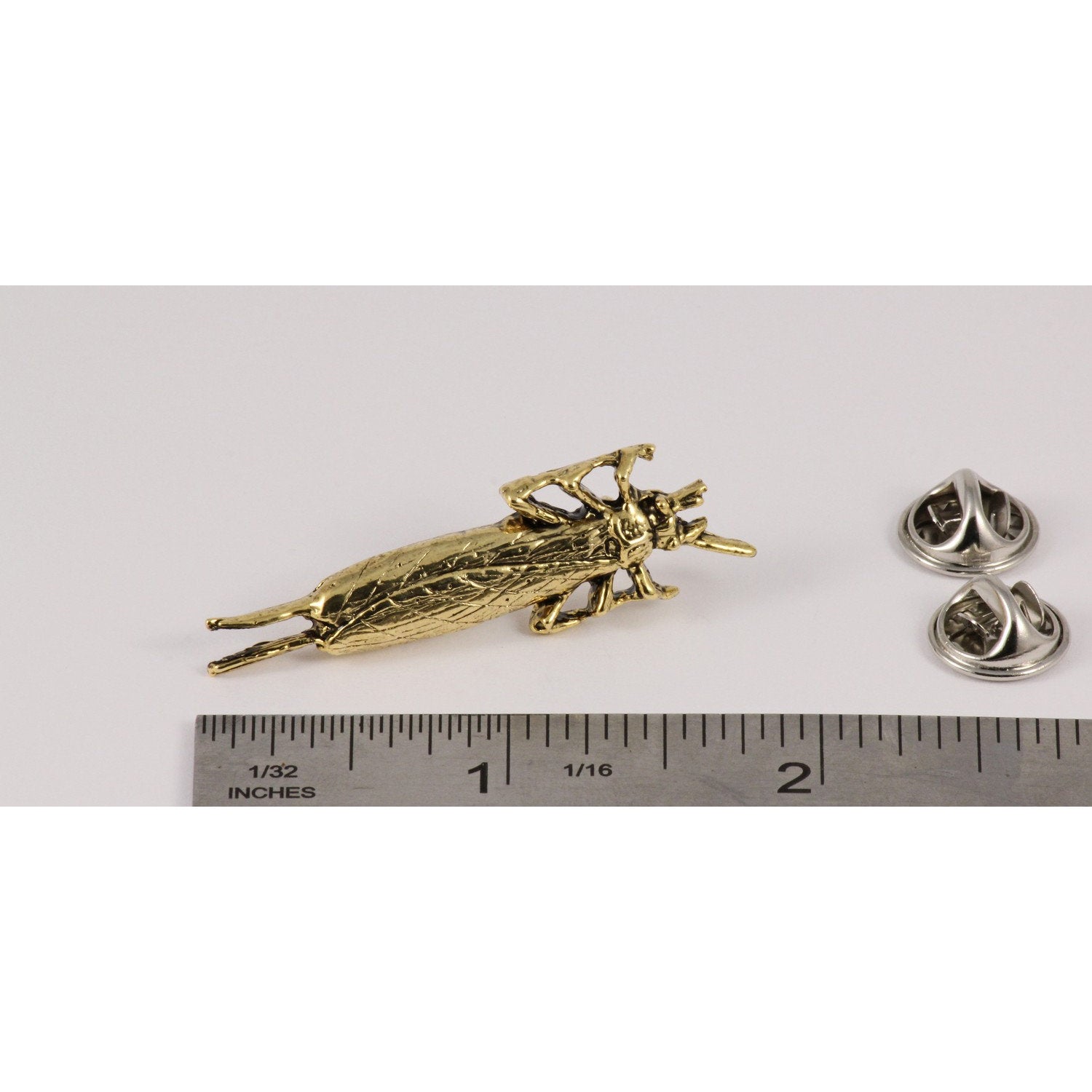 A handcrafted Salmon Fly Insect Pin next to a ruler, available for sale at Creativeartisan.com - the image offers a sense of scale