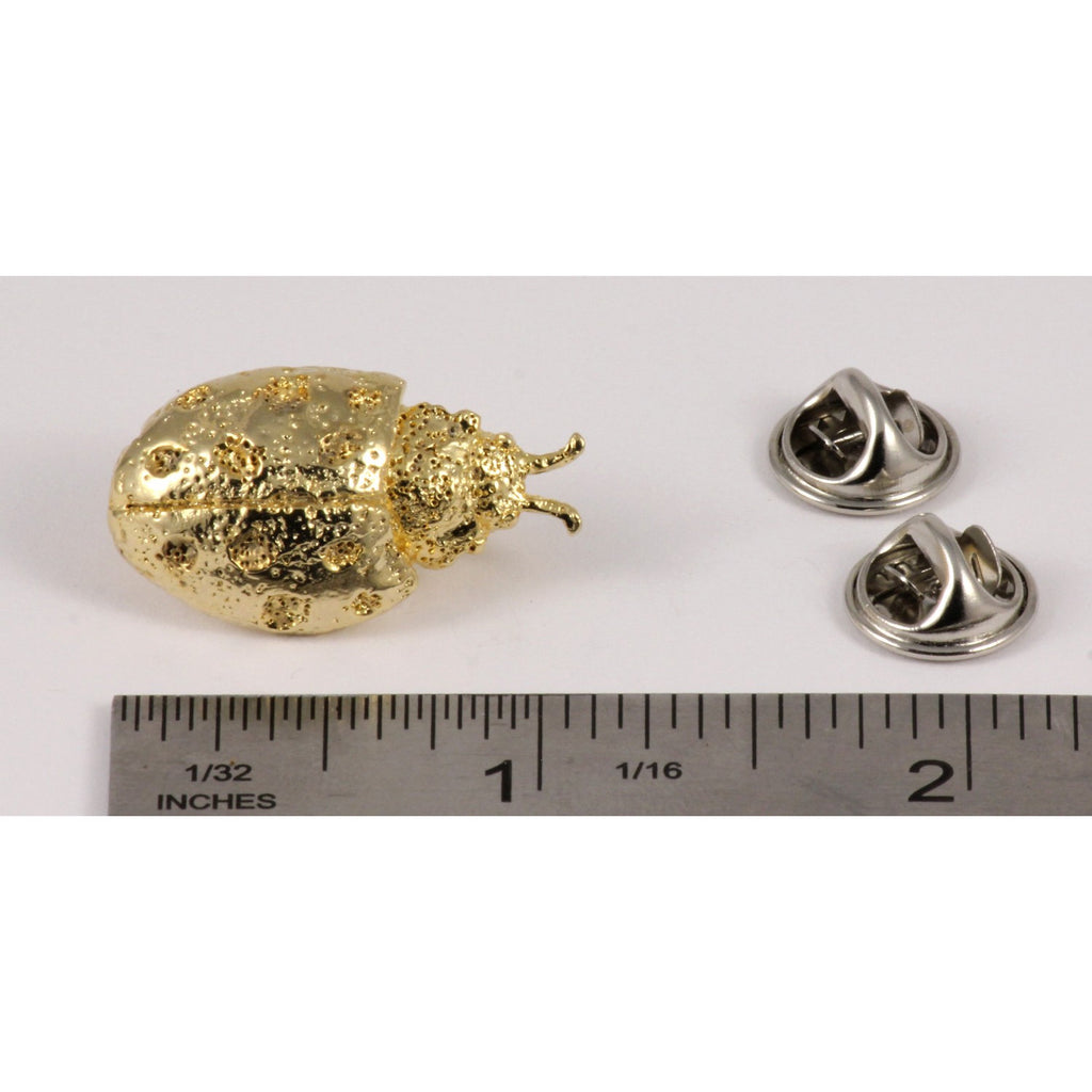 A handcrafted Ladybug Pin next to a ruler, available for sale at Creativeartisan.com - the image offers a sense of scale