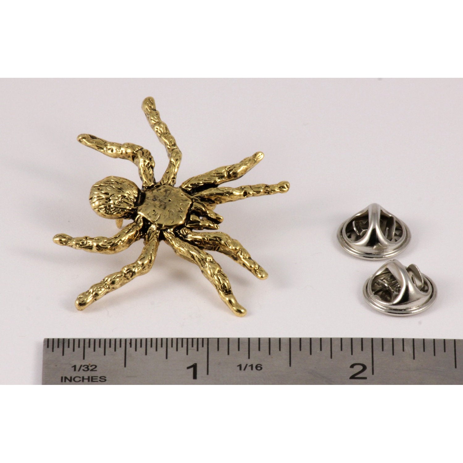 A handcrafted Tarantula Pin next to a ruler, available for sale at Creativeartisan.com - the image offers a sense of scale