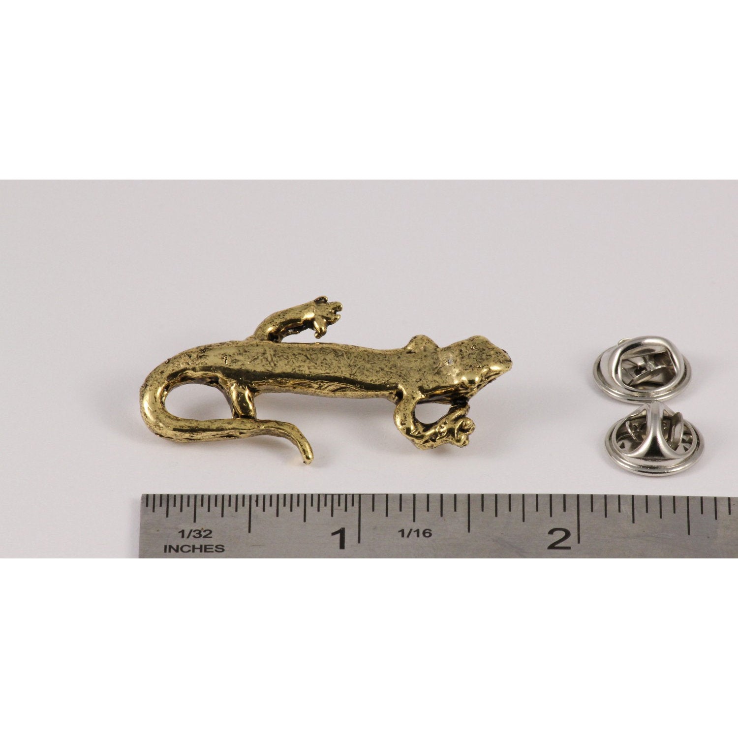A handcrafted Salamander Pin next to a ruler, available for sale at Creativeartisan.com - the image offers a sense of scale