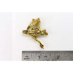 A handcrafted Frog On Branch Pin next to a ruler, available for sale at Creativeartisan.com - the image offers a sense of scale