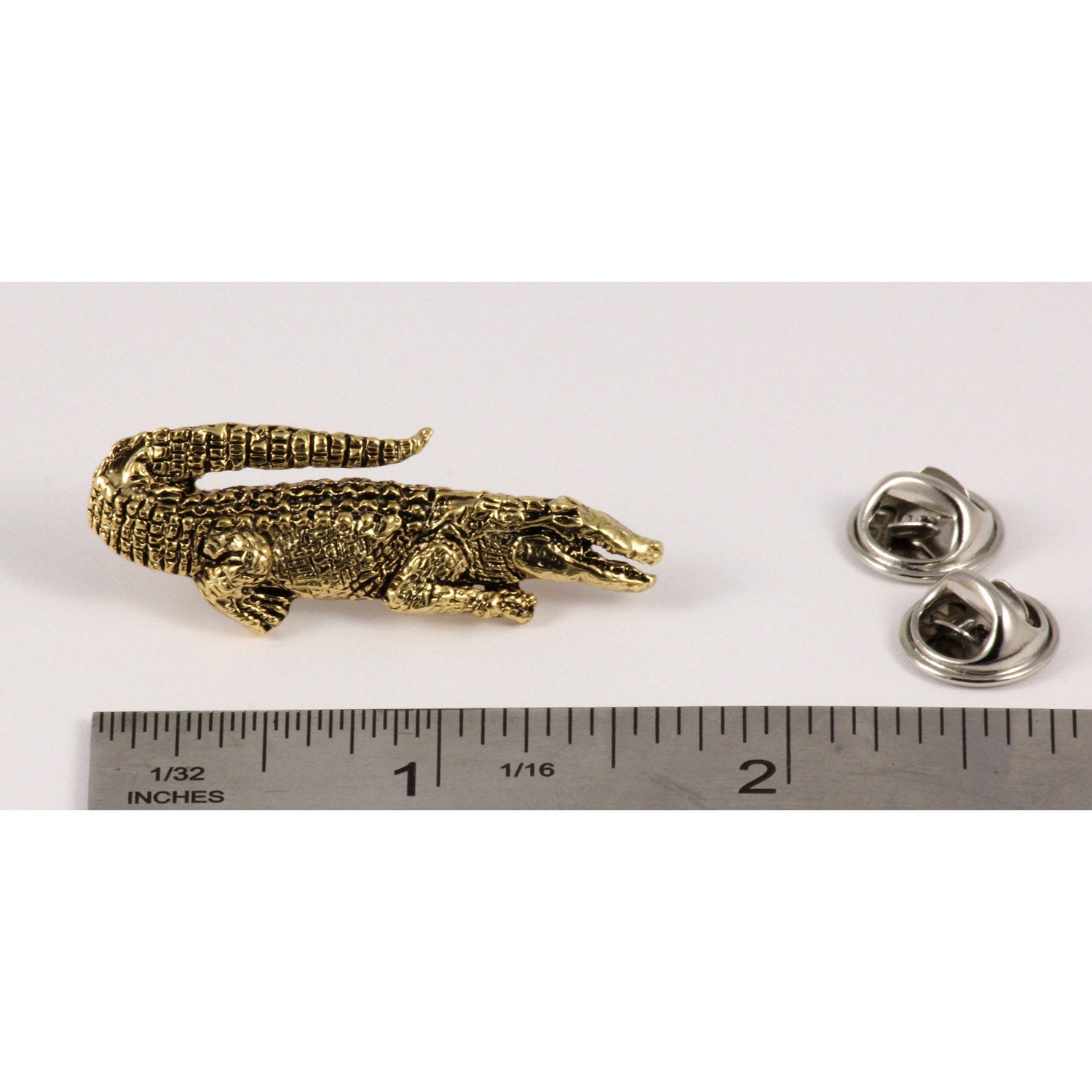A handcrafted Alligator Pin next to a ruler, available for sale at Creativeartisan.com - the image offers a sense of scale