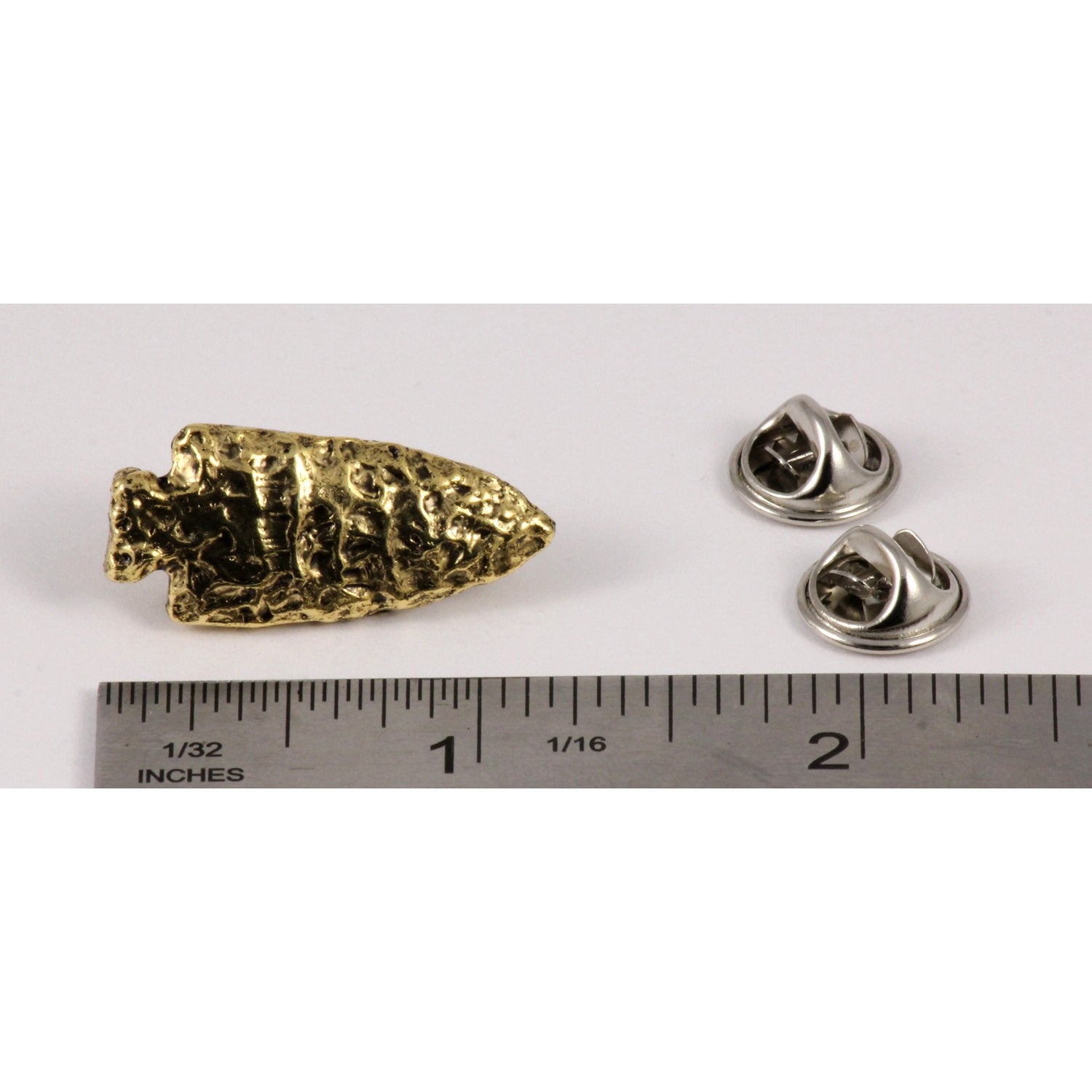 A handcrafted Native American Arrowhead Pin next to a ruler, available for sale at Creativeartisan.com - the image offers a sense of scale