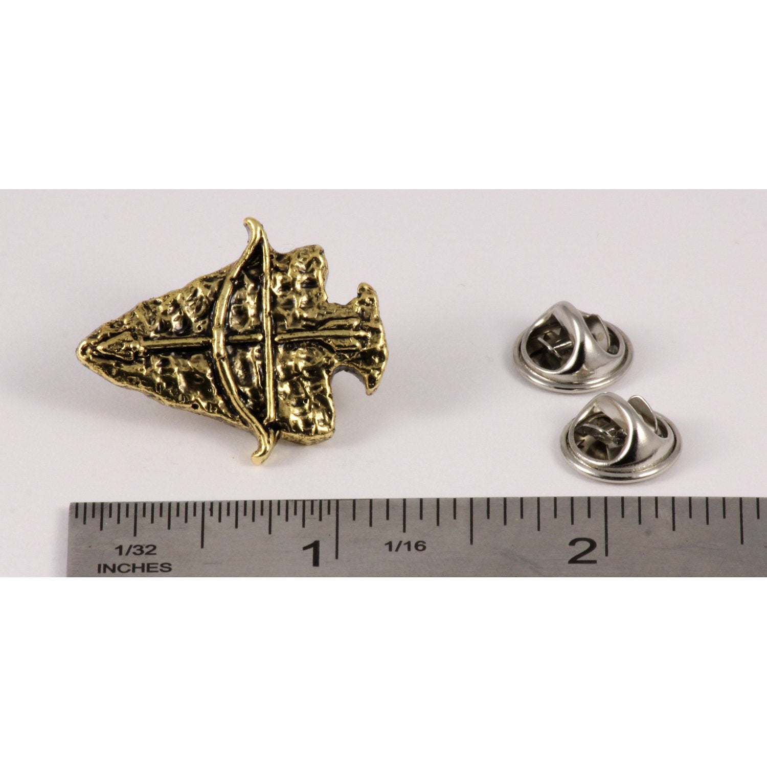 A handcrafted Arrowhead With Bow Pin next to a ruler, available for sale at Creativeartisan.com - the image offers a sense of scale