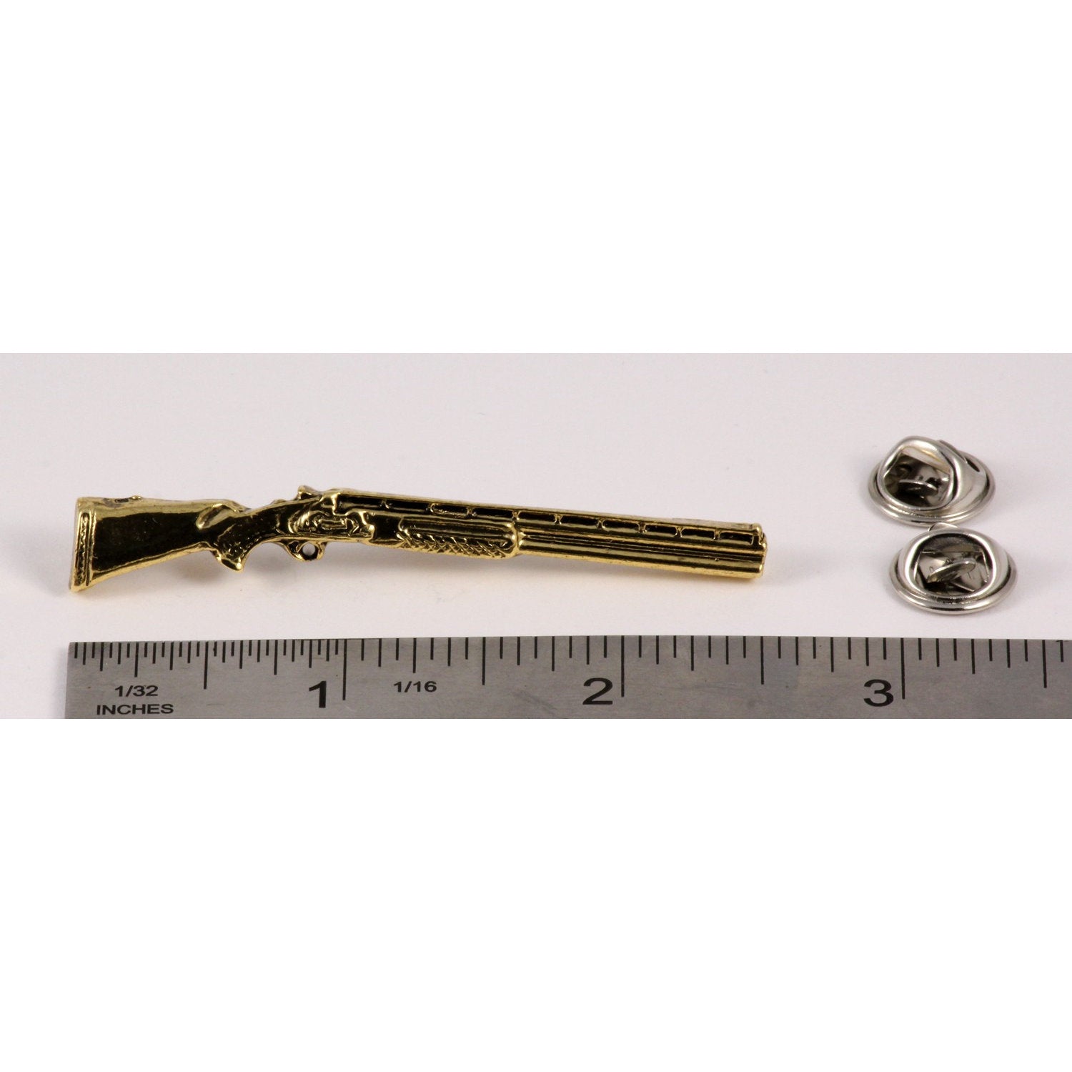 A handcrafted Over Under Shotgun Pin next to a ruler, available for sale at Creativeartisan.com - the image offers a sense of scale