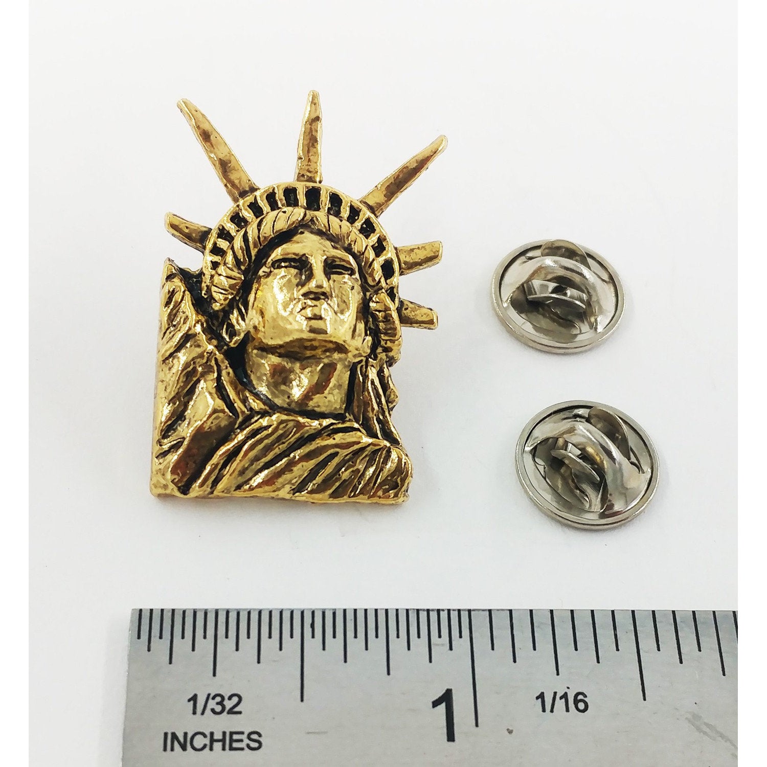 A handcrafted Lady Liberty Pin next to a ruler, available for sale at Creativeartisan.com - the image offers a sense of scale