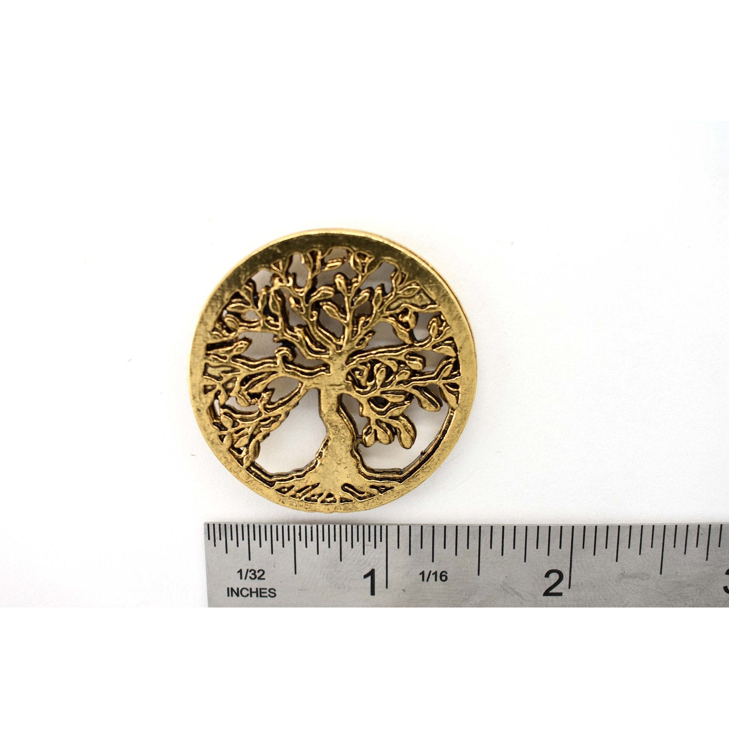 A handcrafted Tree Of Life Pin next to a ruler, available for sale at Creativeartisan.com - the image offers a sense of scale