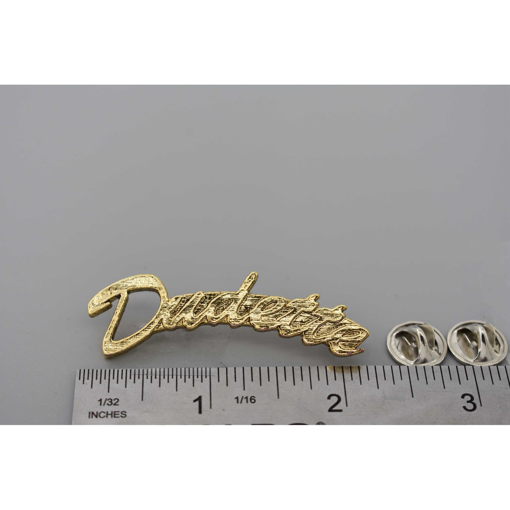 A handcrafted Dudette Pin next to a ruler, available for sale at Creativeartisan.com - the image offers a sense of scale