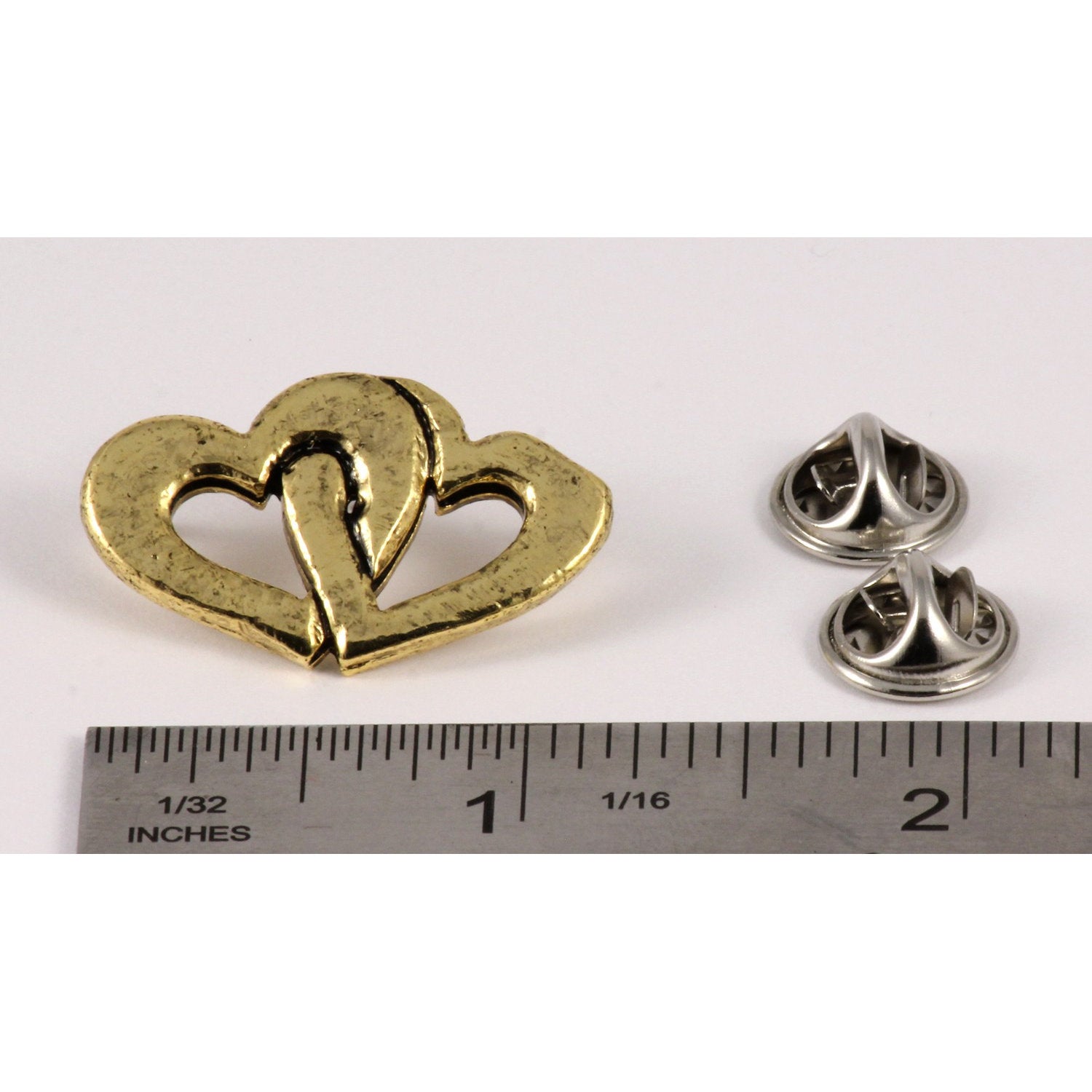 A handcrafted Double Heart Pin next to a ruler, available for sale at Creativeartisan.com - the image offers a sense of scale