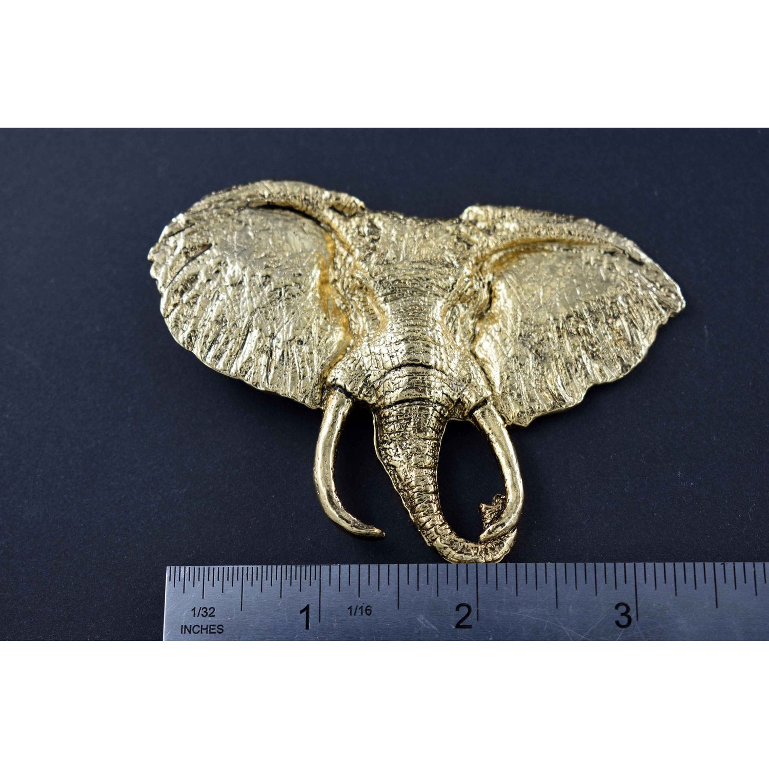 A handcrafted Elephant With Tusks Pin next to a ruler, available for sale at Creativeartisan.com - the image offers a sense of scale