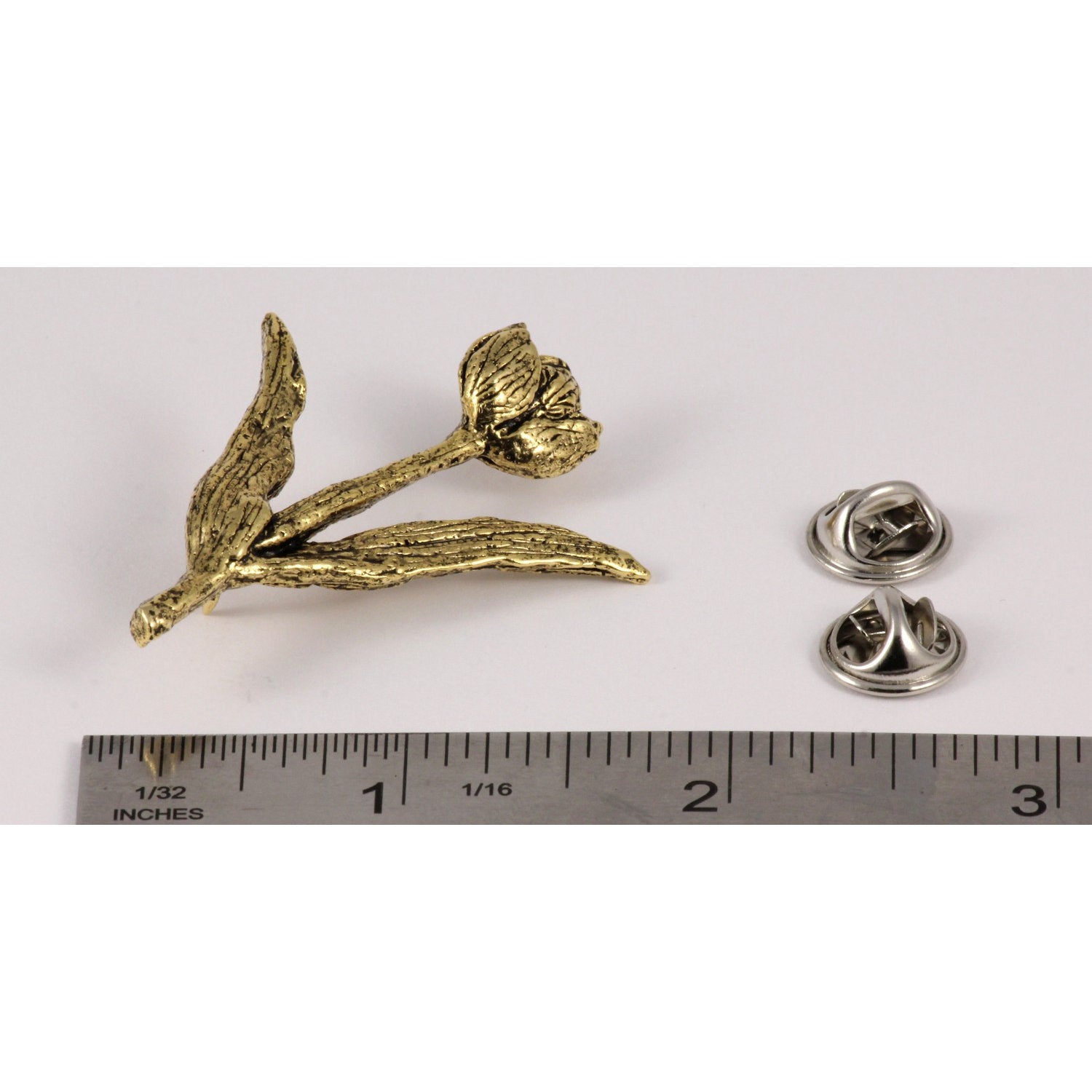 A handcrafted Tulip Pin next to a ruler, available for sale at Creativeartisan.com - the image offers a sense of scale