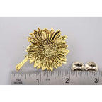 A handcrafted Sunflower Pin next to a ruler, available for sale at Creativeartisan.com - the image offers a sense of scale