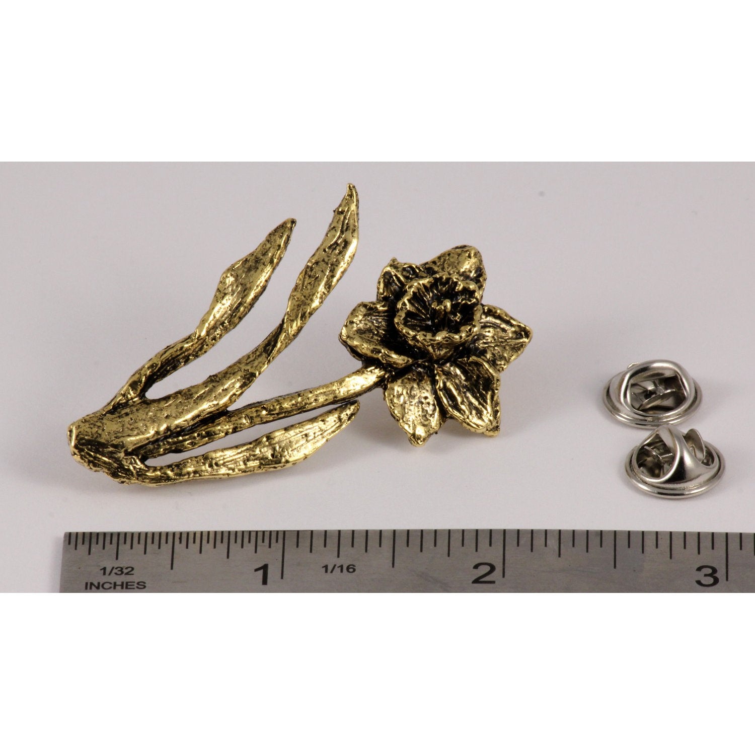 A handcrafted Daffodil Pin next to a ruler, available for sale at Creativeartisan.com - the image offers a sense of scale