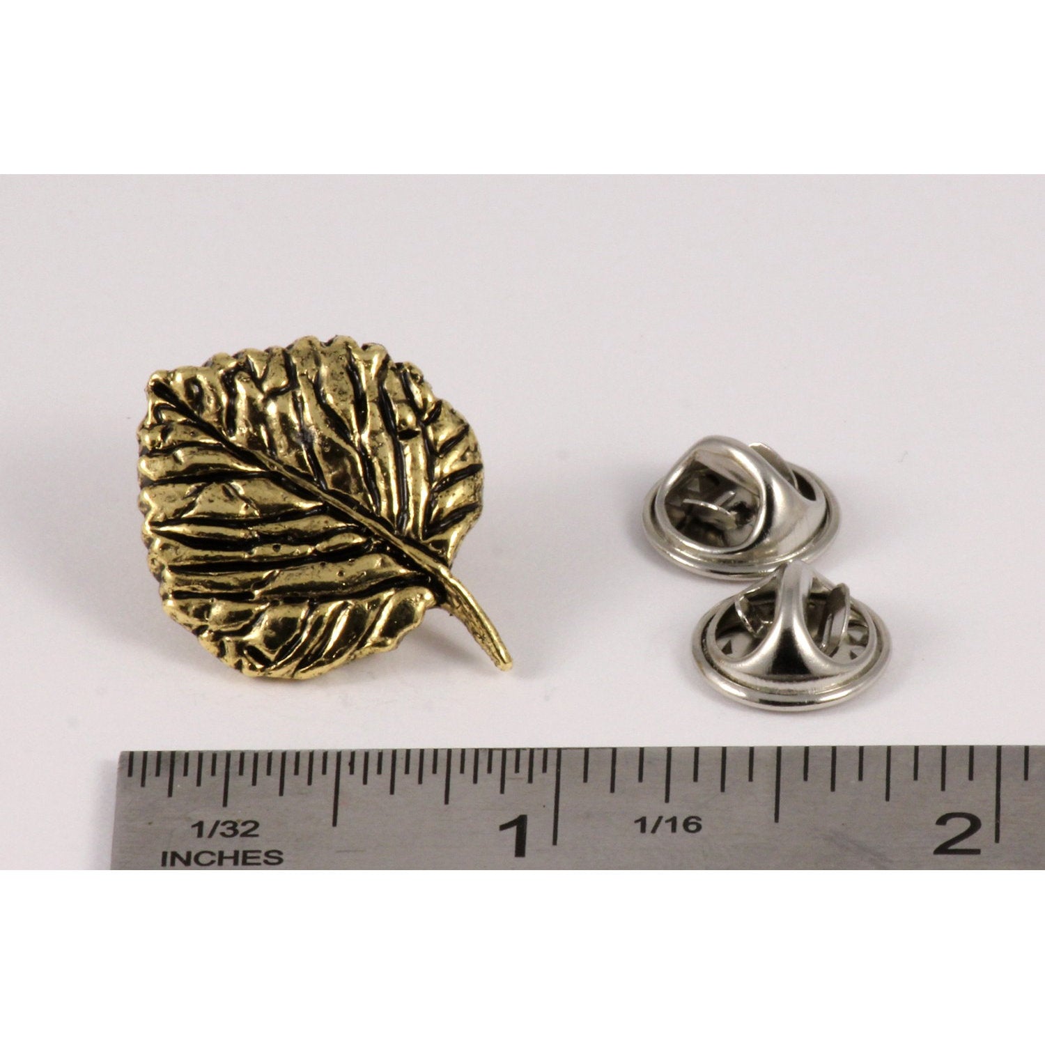 A handcrafted Aspen Leaf Pin next to a ruler, available for sale at Creativeartisan.com - the image offers a sense of scale