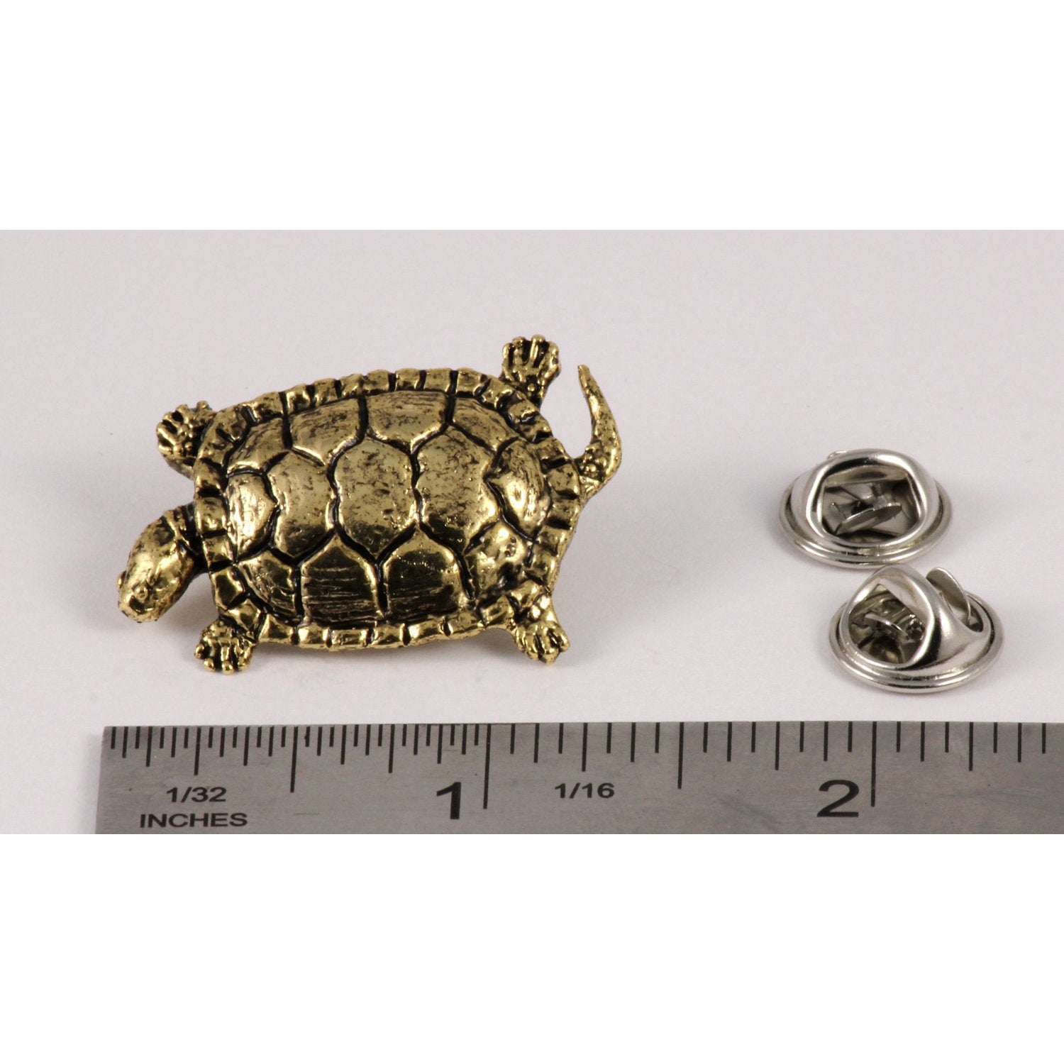 A handcrafted Pond Turtle Pin next to a ruler, available for sale at Creativeartisan.com - the image offers a sense of scale
