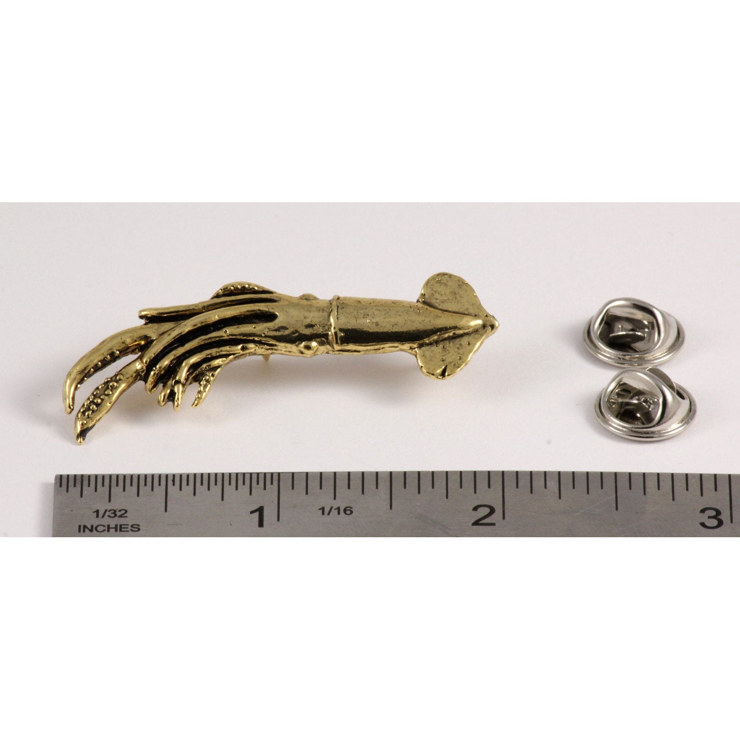 A handcrafted Squid Pin next to a ruler, available for sale at Creativeartisan.com - the image offers a sense of scale