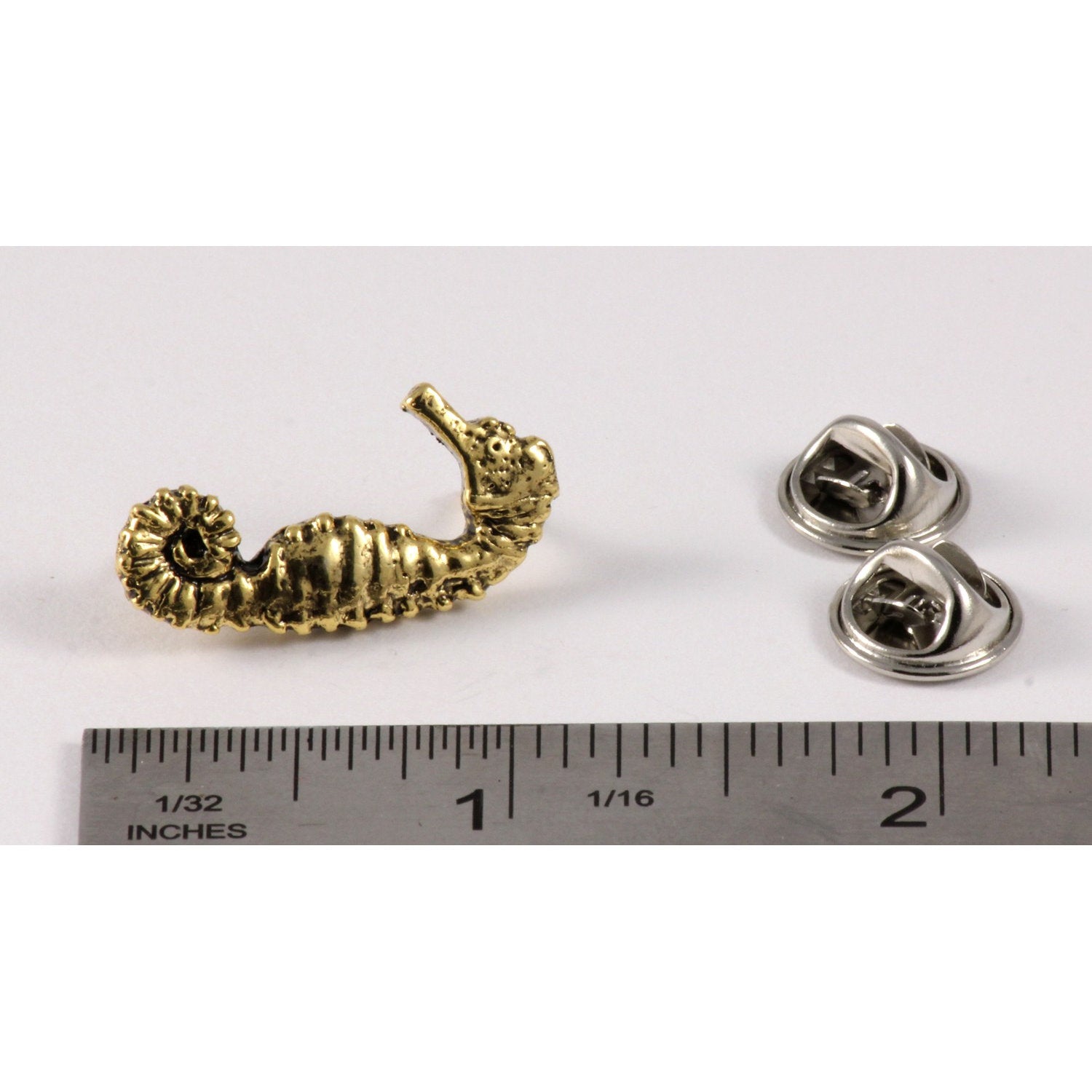 A handcrafted Seahorse Pin next to a ruler, available for sale at Creativeartisan.com - the image offers a sense of scale