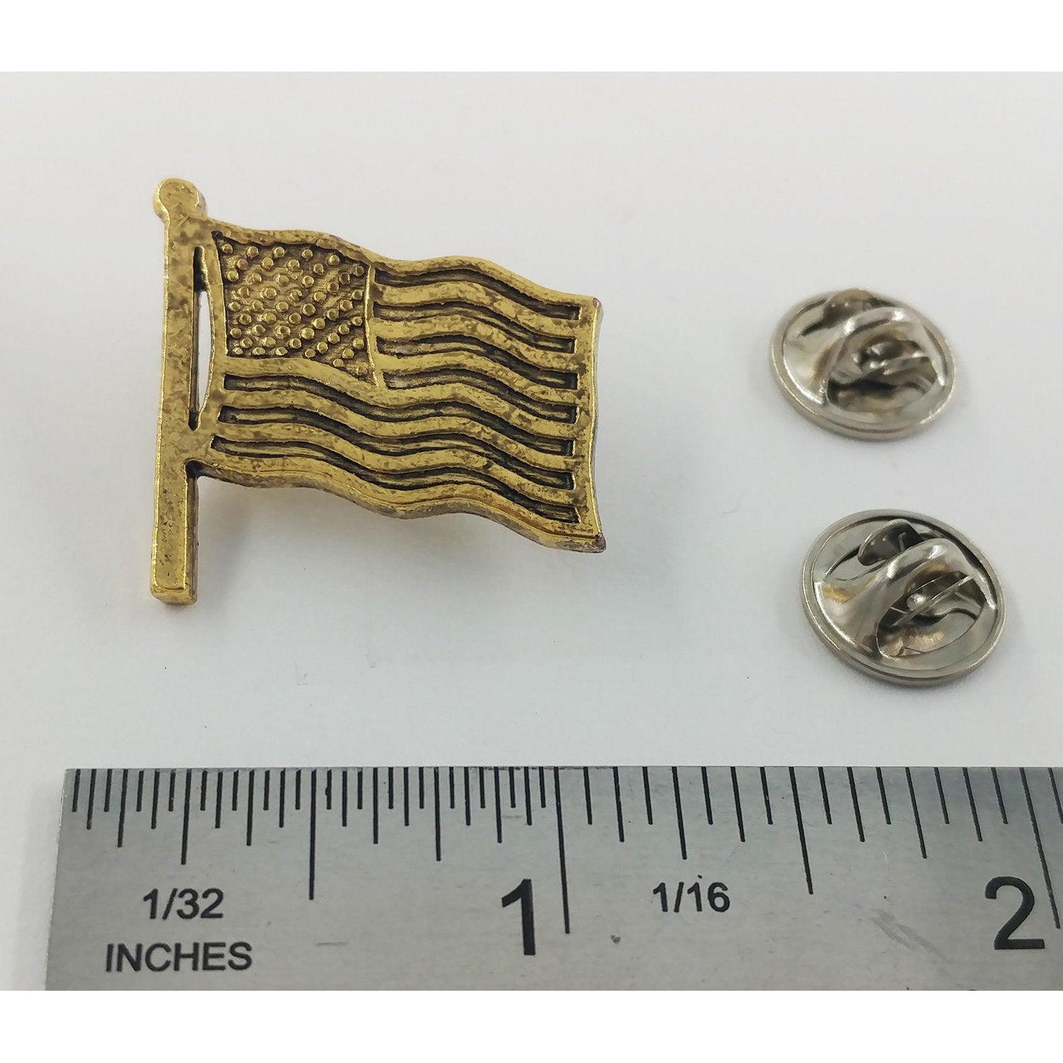 A handcrafted American Flag Waving Pin next to a ruler, available for sale at Creativeartisan.com - the image offers a sense of scale
