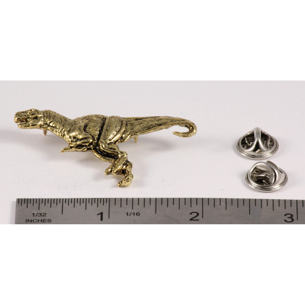 A handcrafted Tyrannosaurus Rex Pin next to a ruler, available for sale at Creativeartisan.com - the image offers a sense of scale
