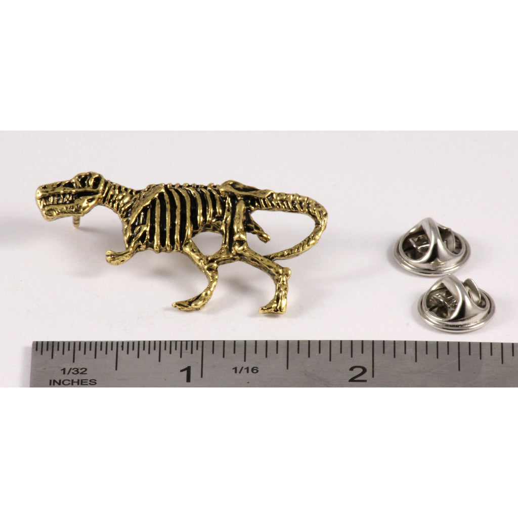 A handcrafted Tyrannosaurus Rex Fossilized Body Pin next to a ruler, available for sale at Creativeartisan.com - the image offers a sense of scale