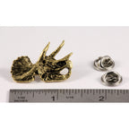 A handcrafted Triceratops Fossilized Head Pin next to a ruler, available for sale at Creativeartisan.com - the image offers a sense of scale