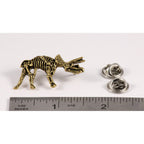A handcrafted Triceratops Fossilized Full Body Pin next to a ruler, available for sale at Creativeartisan.com - the image offers a sense of scale
