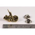 A handcrafted Triceratops Head Pin next to a ruler, available for sale at Creativeartisan.com - the image offers a sense of scale