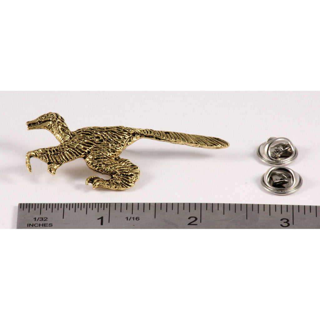 A handcrafted Feathered Velociraptor Pin next to a ruler, available for sale at Creativeartisan.com - the image offers a sense of scale