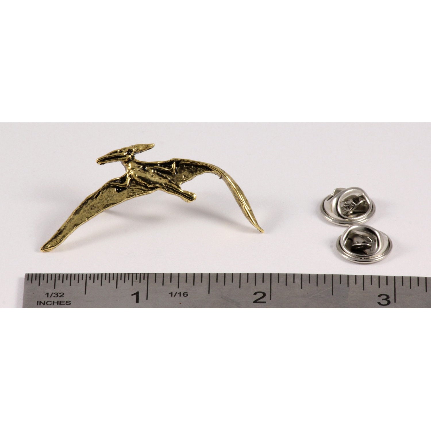 A handcrafted Pterodactyl Flying Pin next to a ruler, available for sale at Creativeartisan.com - the image offers a sense of scale