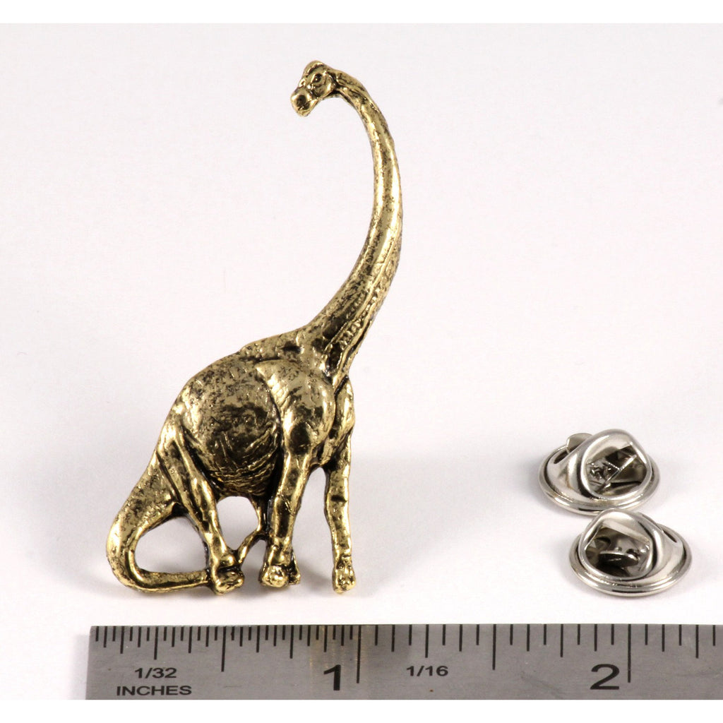 A handcrafted Brontosaurus Pin next to a ruler, available for sale at Creativeartisan.com - the image offers a sense of scale