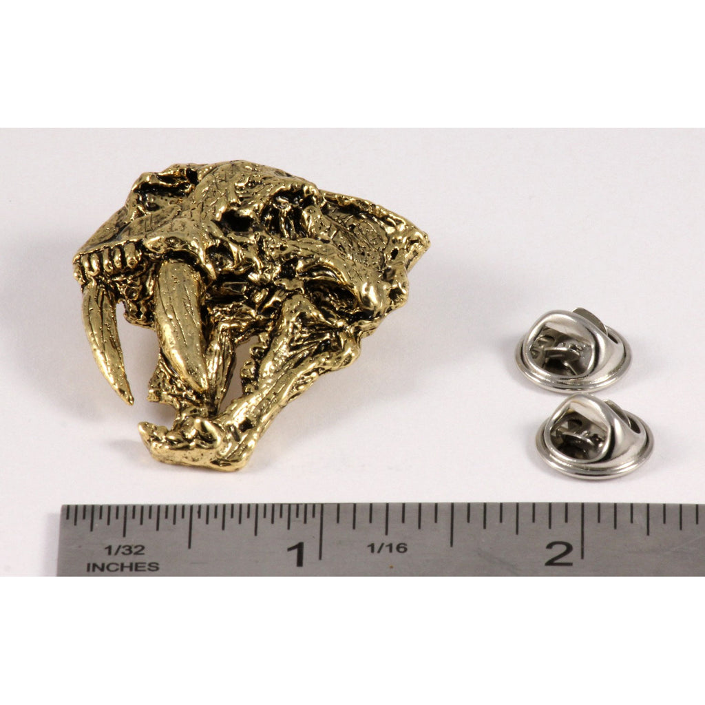 A handcrafted Saber Toothed Cat Skull Pin next to a ruler, available for sale at Creativeartisan.com - the image offers a sense of scale