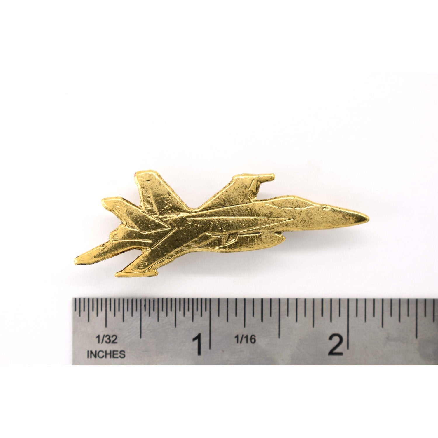 A handcrafted Fighter Jet Pin next to a ruler, available for sale at Creativeartisan.com - the image offers a sense of scale