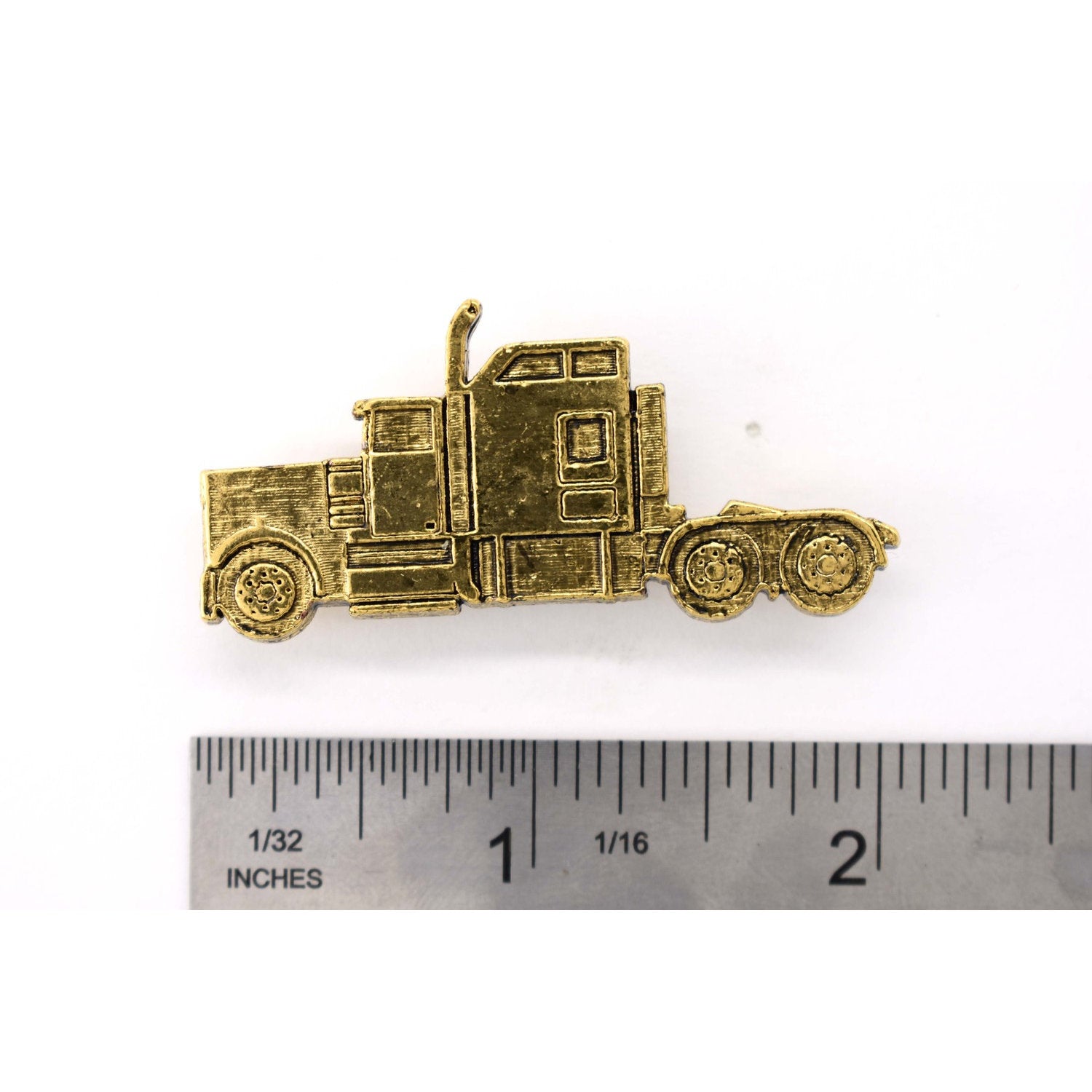 A handcrafted Semi Truck Pin next to a ruler, available for sale at Creativeartisan.com - the image offers a sense of scale